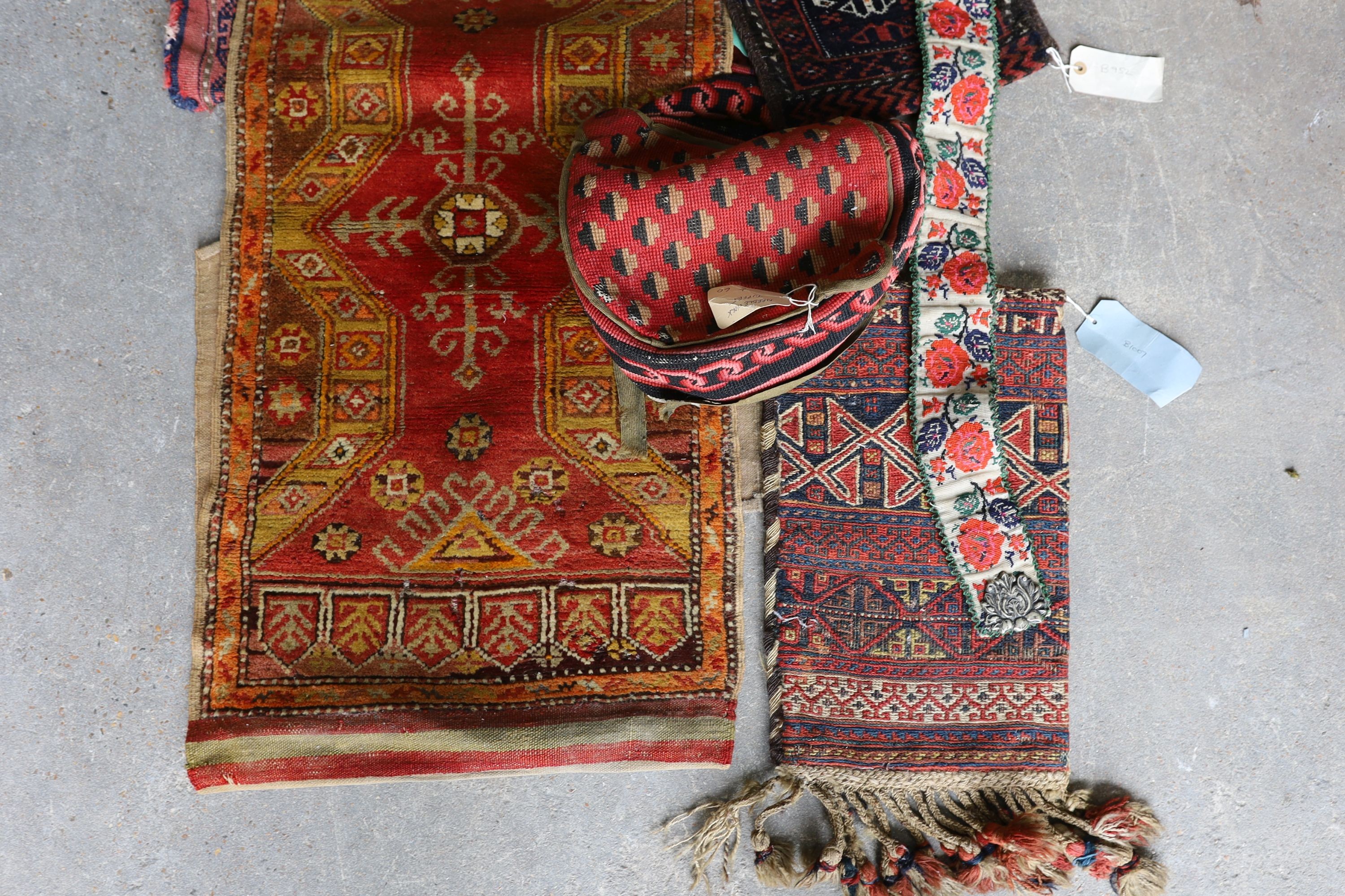 An Afghan Kilim flatweave saddlebag, 144 x 69cm together with six assorted bags, faces, etc.